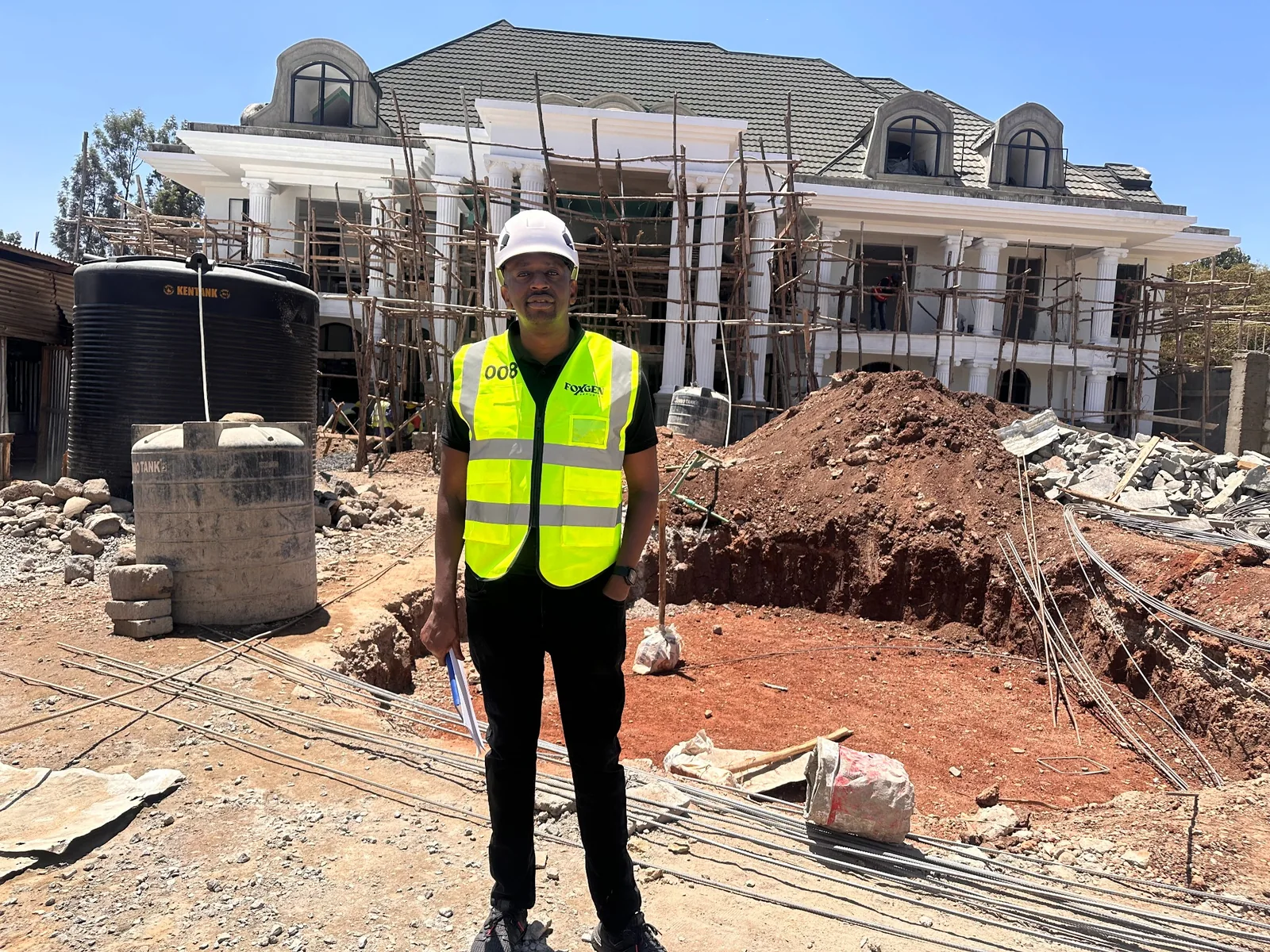 Foxgen technician at a house under construction with scaffolding